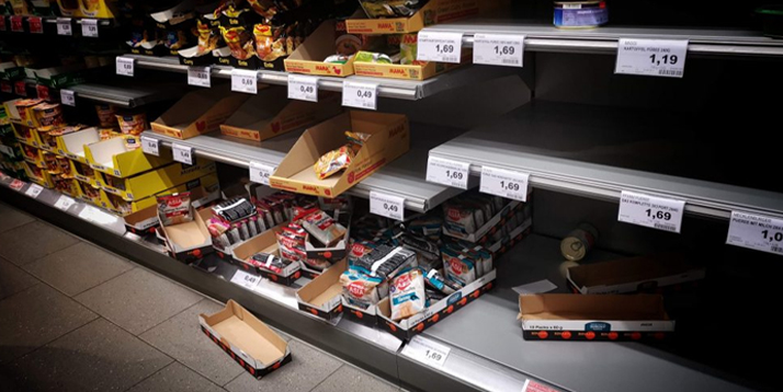 Disorderly grocery shelf with empty and partially filled boxes, indicating low stock and disorganized display of products.