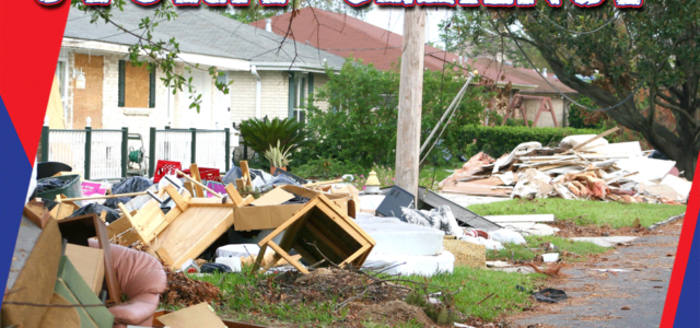 Storm cleanup with debris and furniture piled by the roadside.
