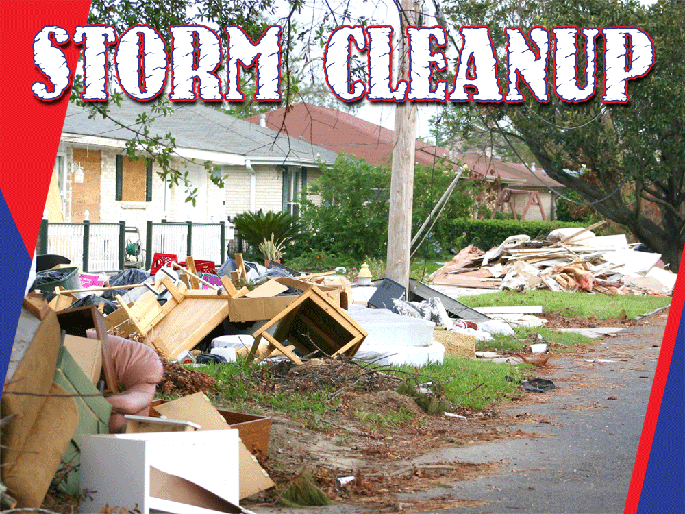 Storm cleanup with debris and furniture piled by the roadside.
